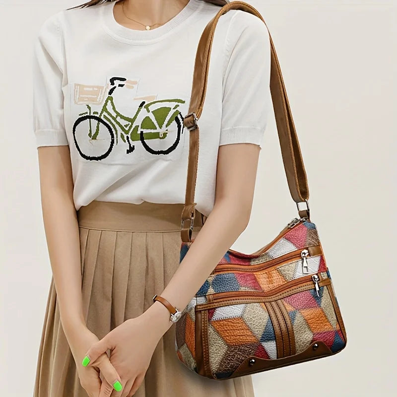 Front view of Avelia multicolor leather shoulder bag showing zip compartments